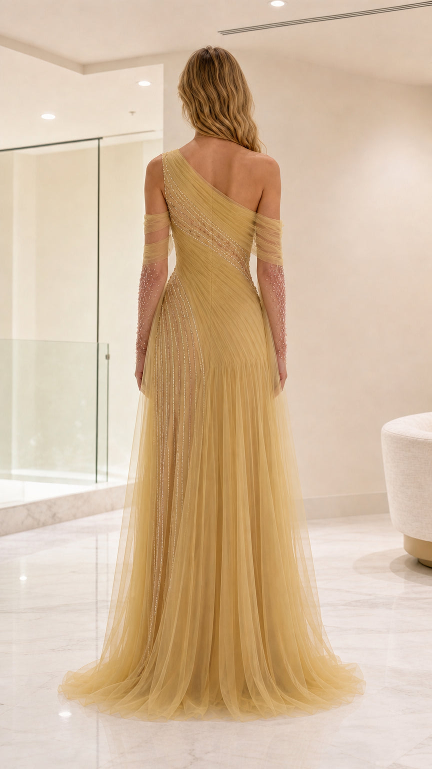 Back view of gold one-shoulder tulle maxi gown with asymmetrical back ruching