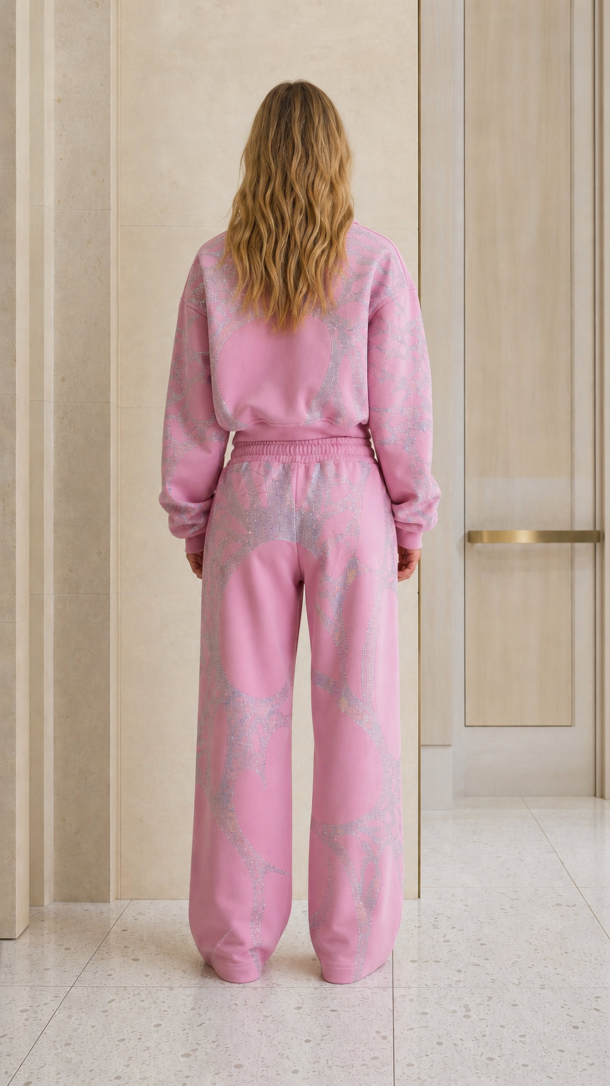 Back view of model in pink rhinestone hoodie and matching sweatpants