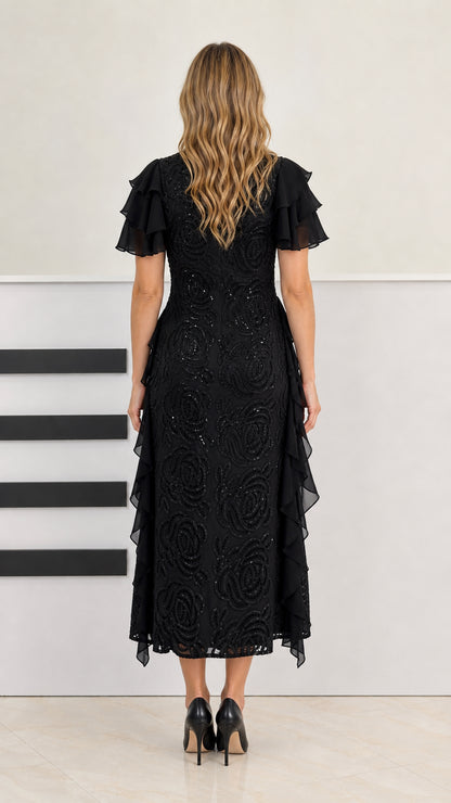 Back view of model in black beaded midi dress