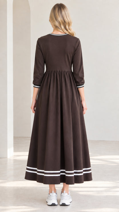 Back view of woman wearing brown 3/4 sleeve swing maxi dress