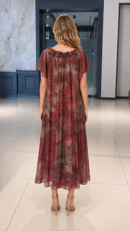 Back view of woman wearing burgundy pleated midi dress