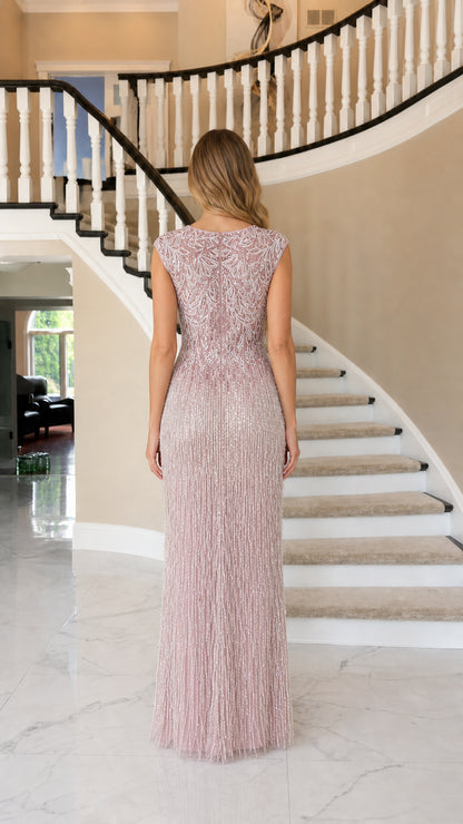 Back view of model showing detailed beadwork on evening dress