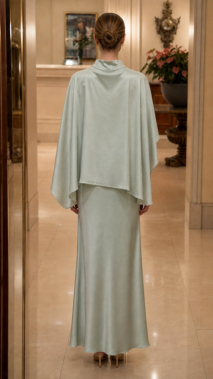 Back view of model showing drape of sage green cape dress