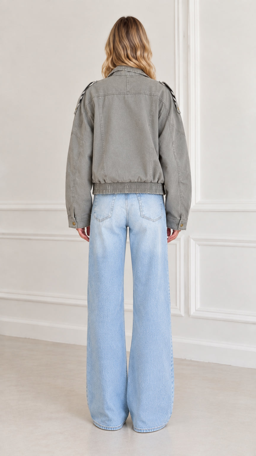 Back view of model showing gathered elastic hem of Sage Green utility jacket