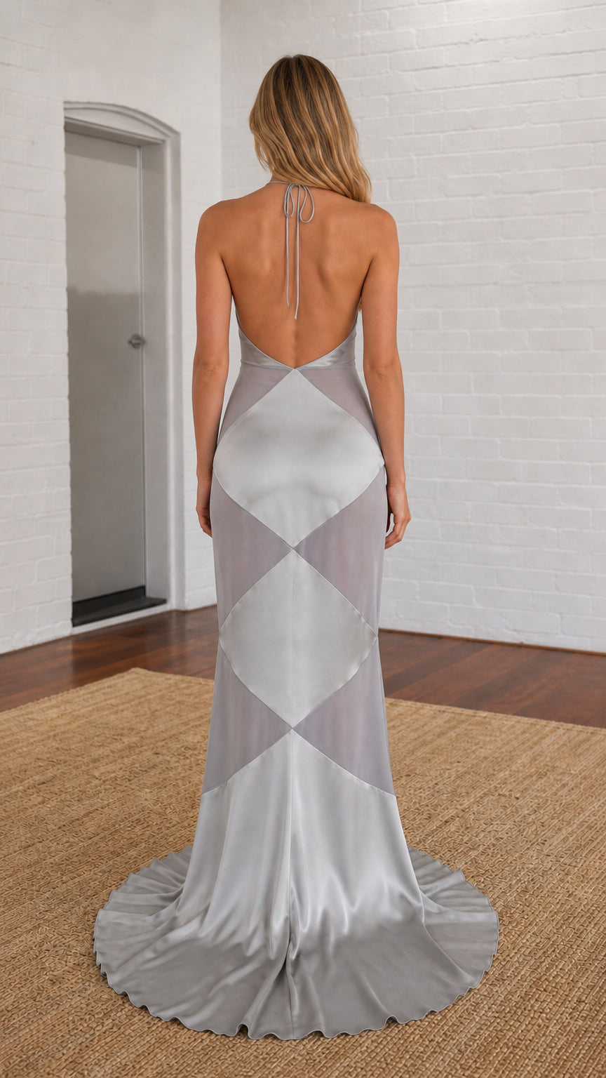Back view of model showing open back design of silver gown