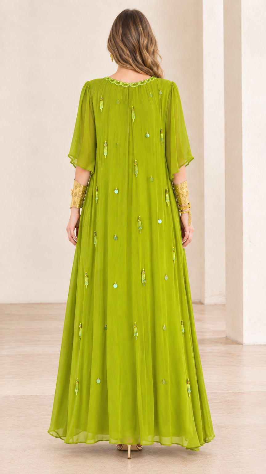 Back view of model in flowing lime green pleated maxi dress