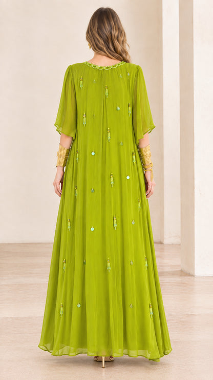 Back view of model in flowing lime green pleated maxi dress