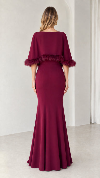 Back view of floor-length burgundy formal dress with cape overlay