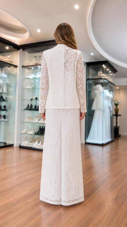 Back view of model in white lace suit showcasing sheer lace back panel and tailored silhouette
