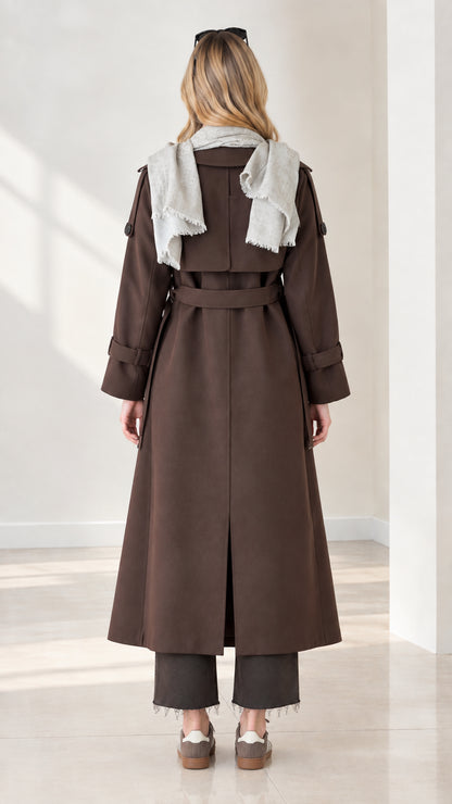 Back view of chocolate brown trench coat showing back vent, storm flap, and waist tie