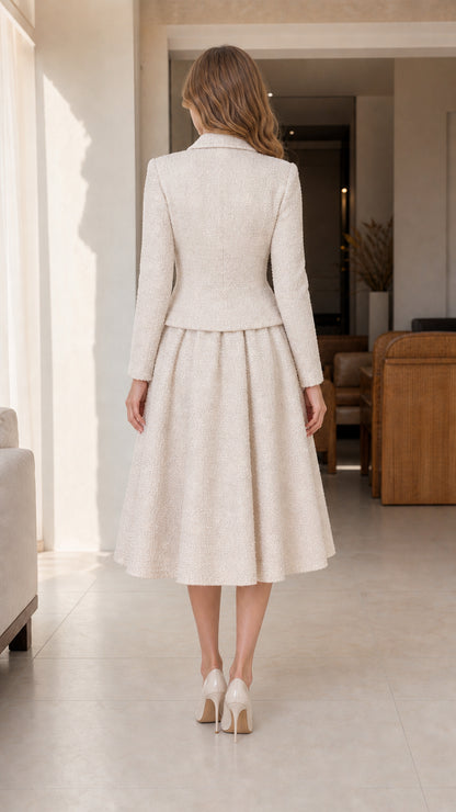 Back view of cream tweed two-piece blazer and pleated midi skirt ensemble