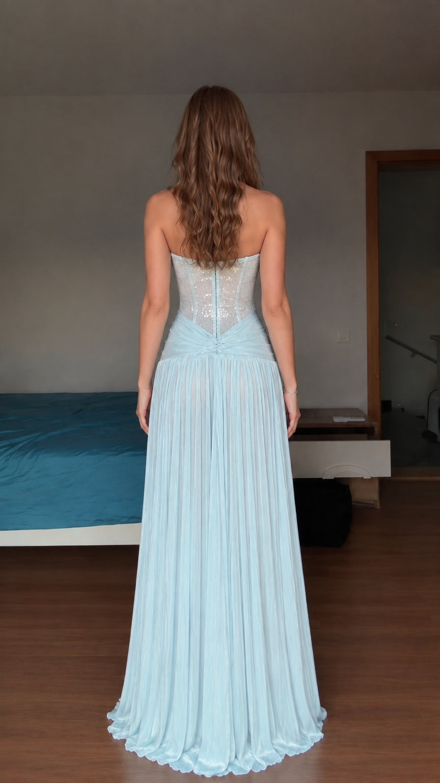Back view of model wearing light blue strapless corset maxi dress