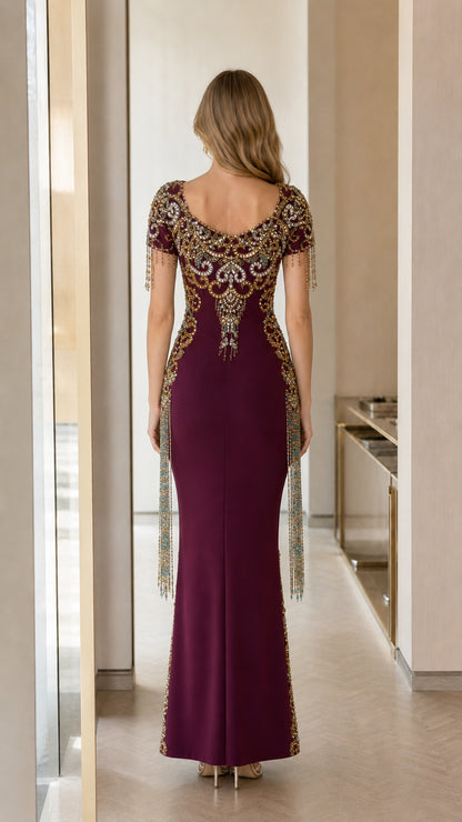 Back view of burgundy formal evening gown with detailed embroidery and floor-length skirt