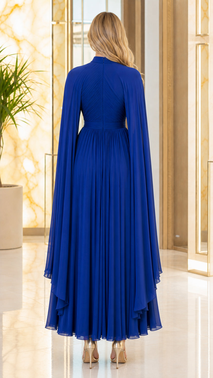 Back view of royal blue floor-length pleated cape evening gown