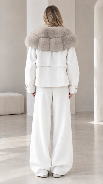 Back view of model in white casual jacket and relaxed wide-leg lounge pants