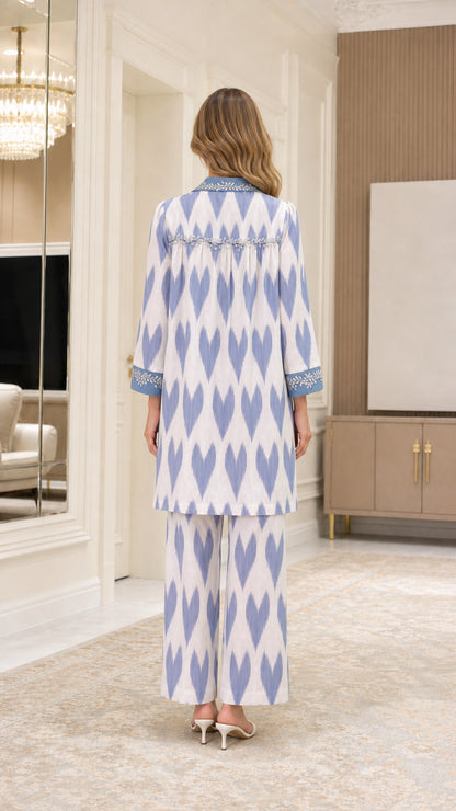 Back view of model showing pleated back detail of Light Blue printed tunic set