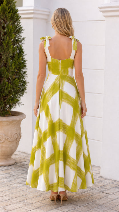 Back view of woman in white and green brushstroke maxi dress