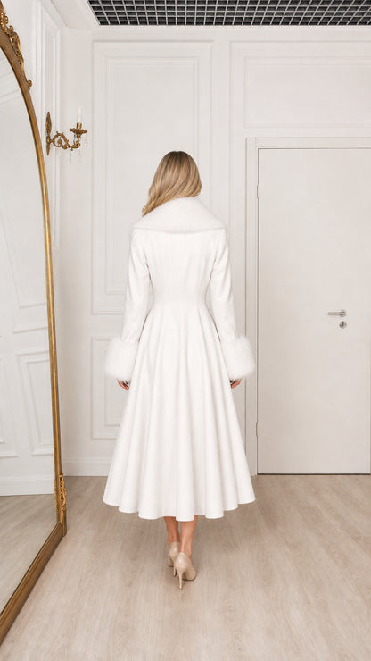 Model in white midi overcoat with fur cuffs and collar back view