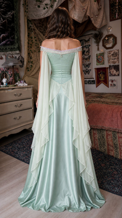 Back view of sage green gown showing draped sheer overlays
