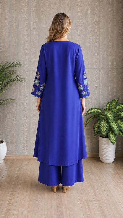 Model wearing royal blue embroidered tunic set, back view
