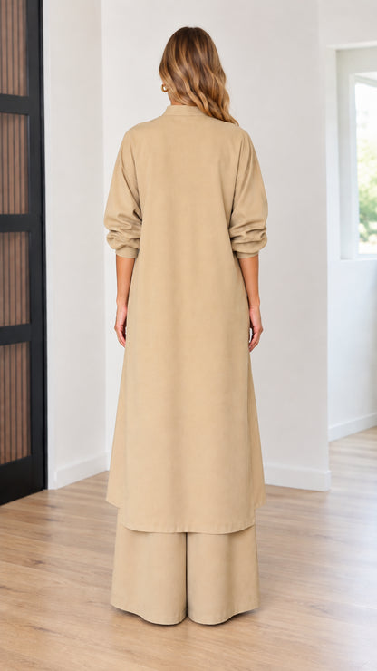 Back view of model wearing beige longline tunic top and wide-leg matching pant set