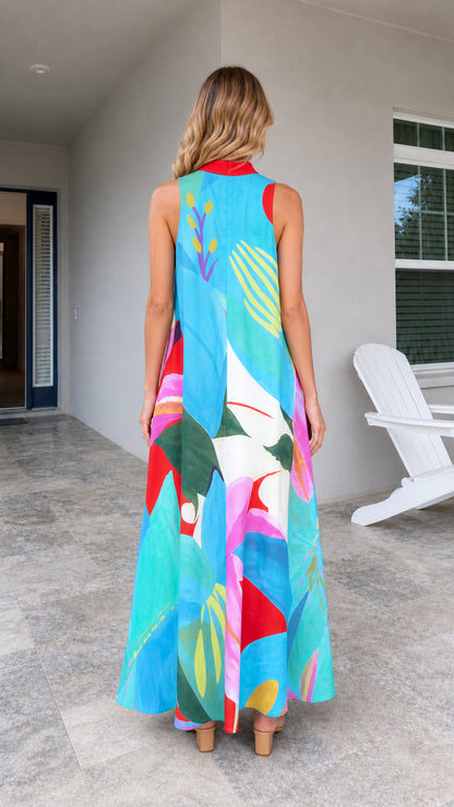 Back view of model wearing blue tropical print maxi dress