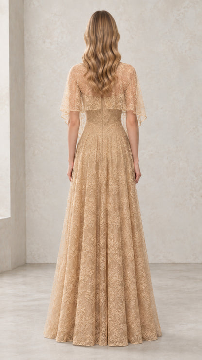 Back view of woman wearing Champagne A-line lace formal gown with cape overlay