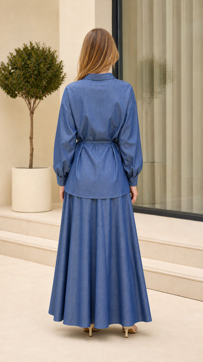 Back view of woman wearing Denim Blue two-piece shirt and maxi skirt set