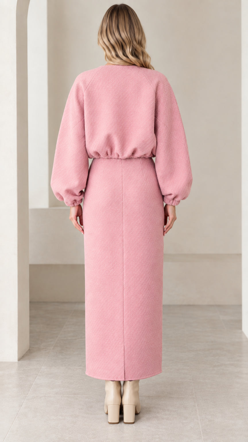 Back view of model in pink textured cropped bomber and maxi skirt