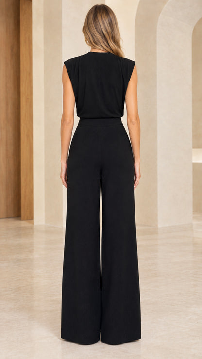 Back view of model wearing black tailored wide leg jumpsuit