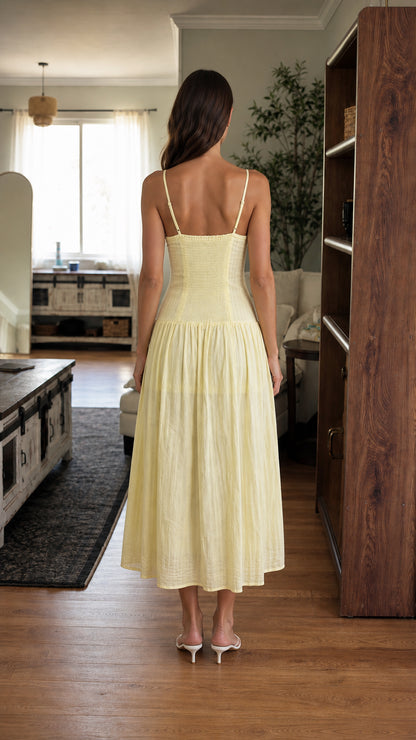 Back view of woman in yellow midi dress