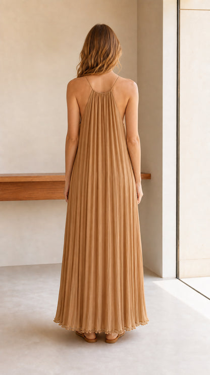 Model wearing camel pleated halter maxi dress, back view