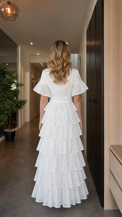 Back view of model wearing white eyelet two-piece maxi skirt set