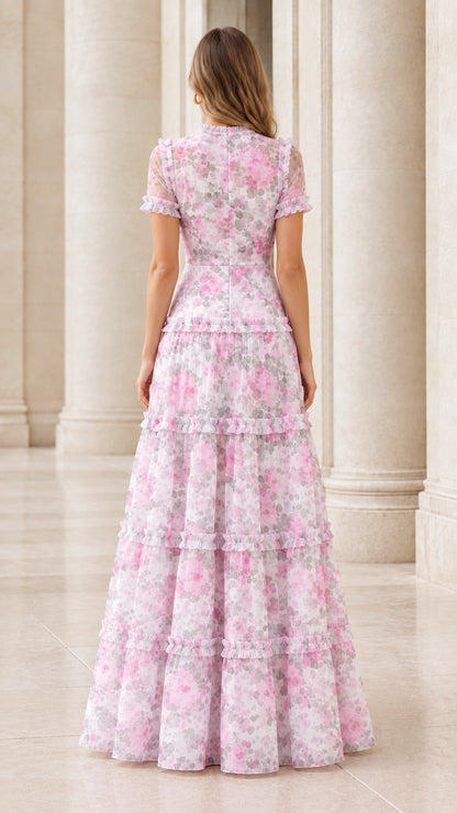 Back view of the pink floral ruffle tiered maxi dress showing waist and tiers