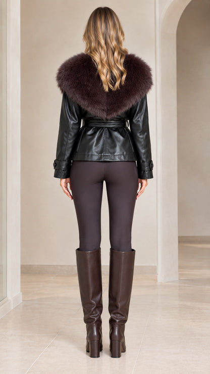 Back view of model showing wide faux fur collar and belted waist on black jacket