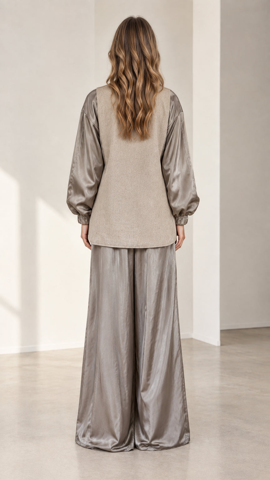 Back view of model wearing relaxed taupe contrast blazer and wide-leg trousers