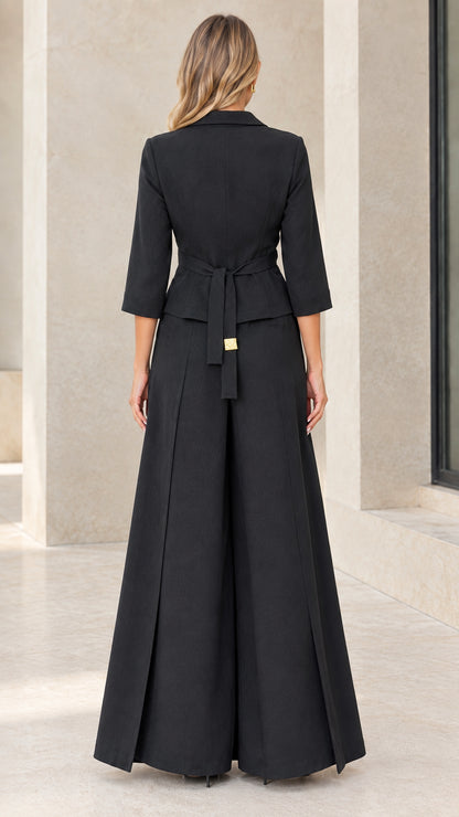 Back view of black pantsuit showing back waist tie belt and pleated trousers