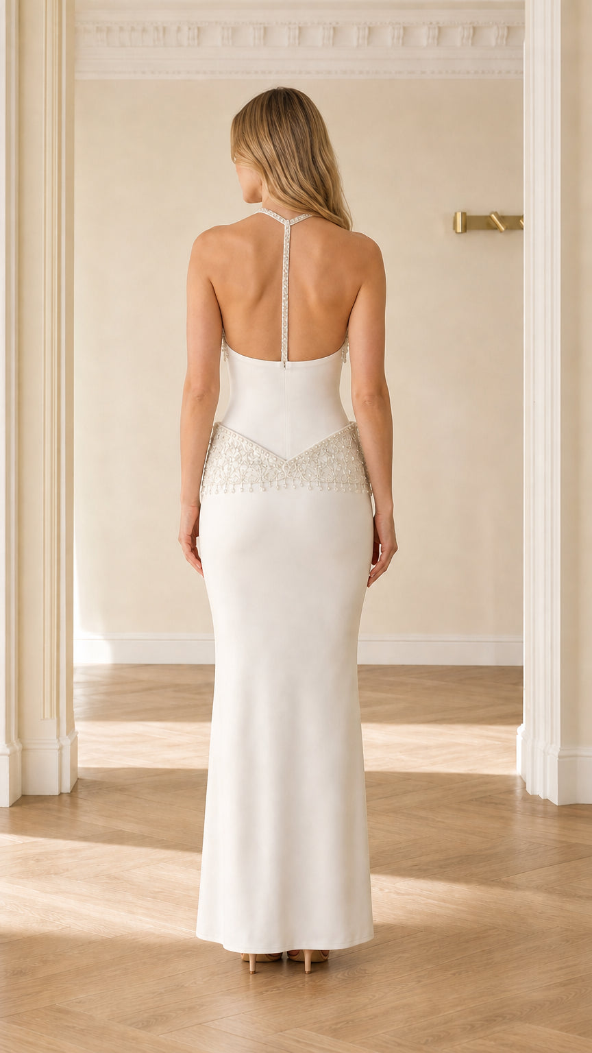 Back view of white open back formal evening gown with beaded strap