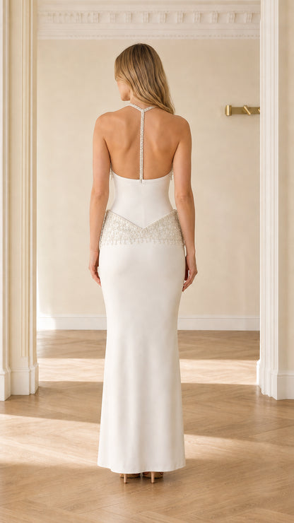 Back view of white open back formal evening gown with beaded strap