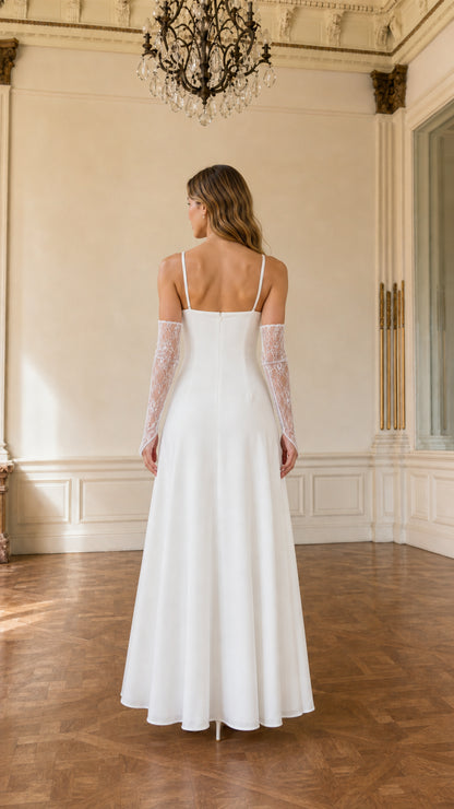 Back view of model in white A-line maxi dress with slim straps