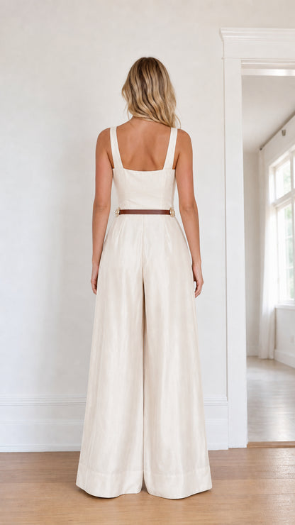 Back view of model wearing ivory wide leg jumpsuit