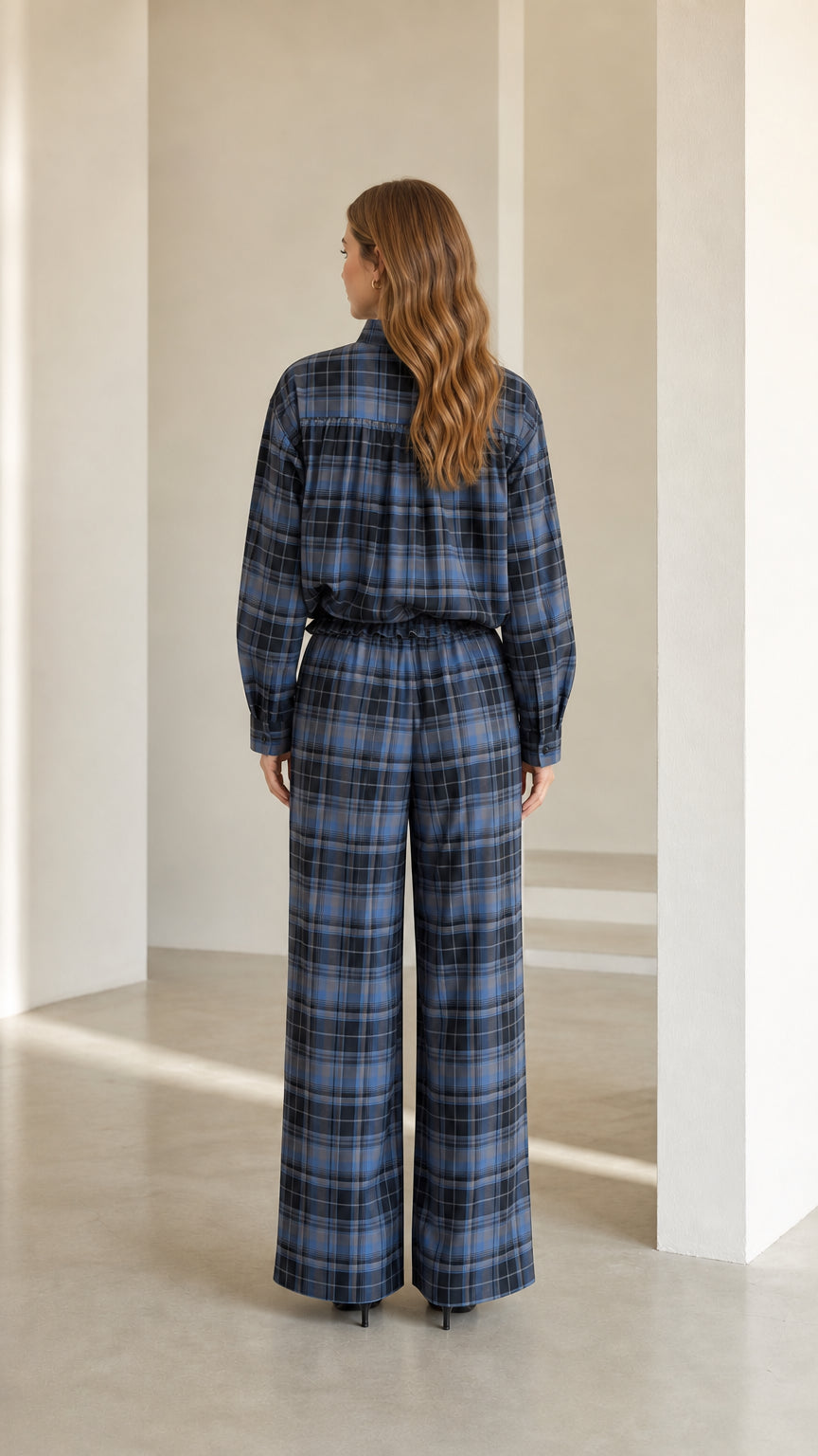 Back view of model showcasing the fit of the blue plaid two-piece coordinated set