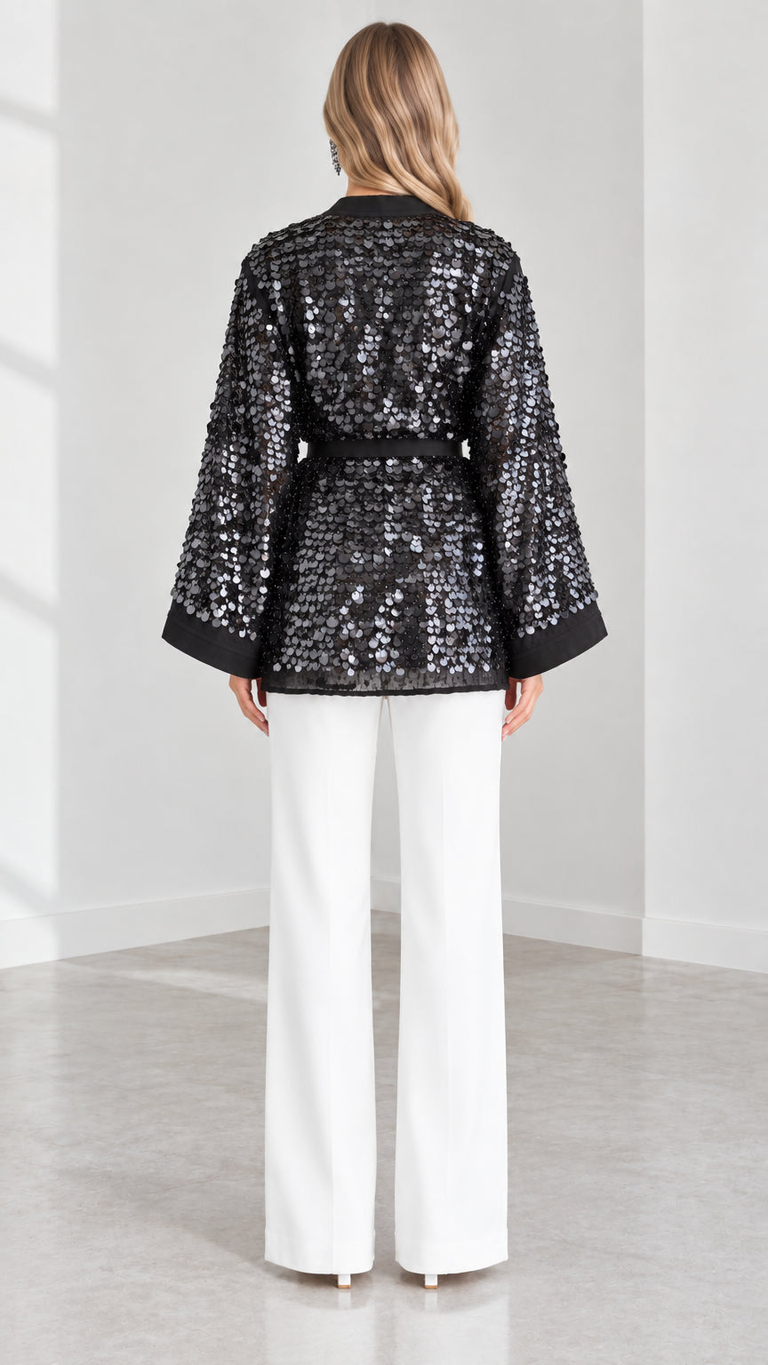 Back view of model wearing Black sequin kimono jacket with contrast banded cuffs