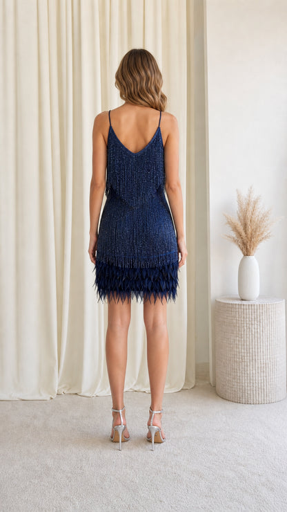 Back view of model showing back straps and fringe detail on Navy dress