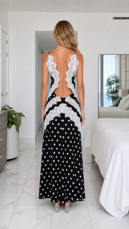 Back view of black polka dot maxi dress showing open back with delicate lace border