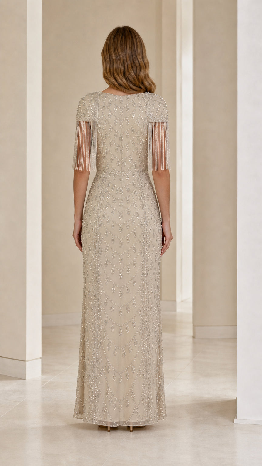 Back view of champagne floor-length formal gown with beaded embroidery