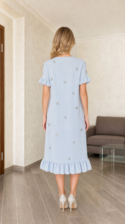 Model wearing light blue embellished midi dress, back view