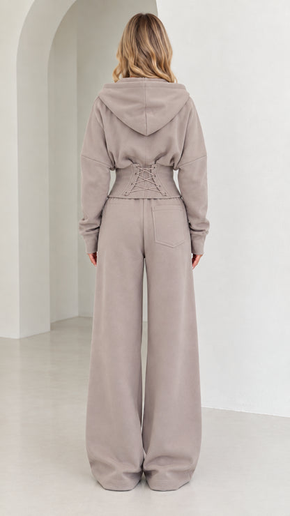 Back view of taupe set highlighting corset lace-up waist detail and wide-leg fit