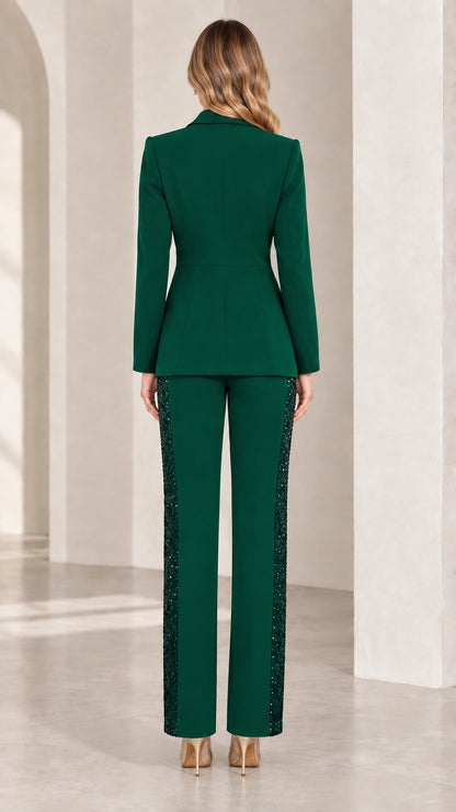 Back view of woman wearing tailored emerald green blazer and straight-leg trousers