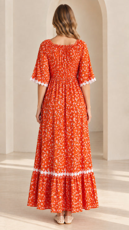 Back view of model showing rust orange gathered floral maxi dress